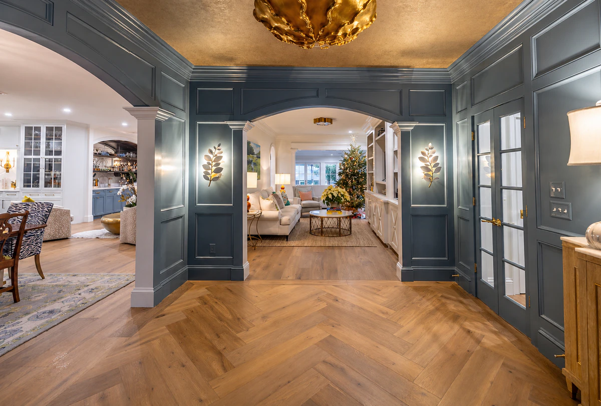 Finished entry hall with blue-grey painted millwork and detailed trim by J&I Coastal Painting